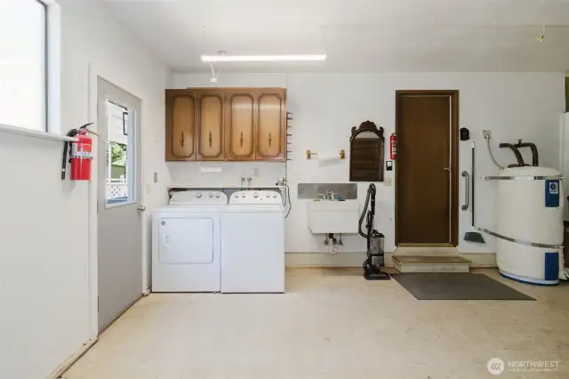 Laundry area in garage with near by utility sink.
