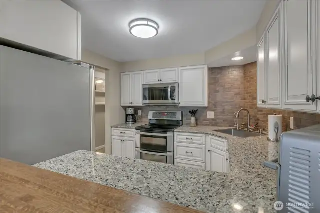 The breakfast bar was custom-made for this kitchen. It is what you see at the bottom of the screen. This adds to the open feel of the home!