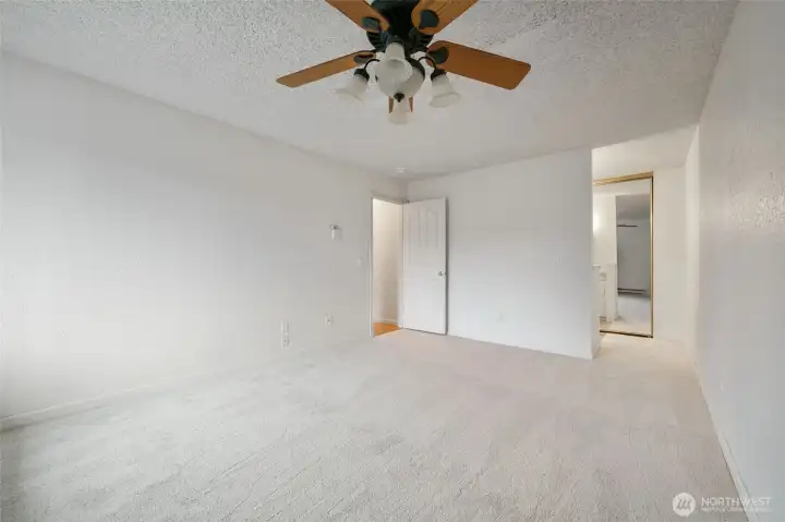 Primary suite with an overhead fan for added comfort and a private bath.