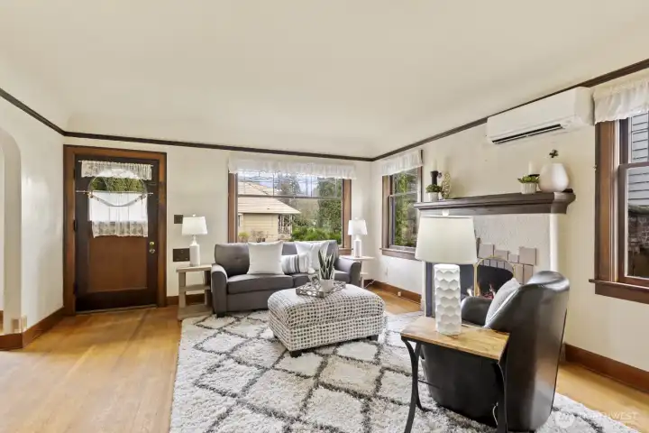 Savor period details including oak floors, coved ceilings, leaded glass windows, trim, doors, and custom fireplace.