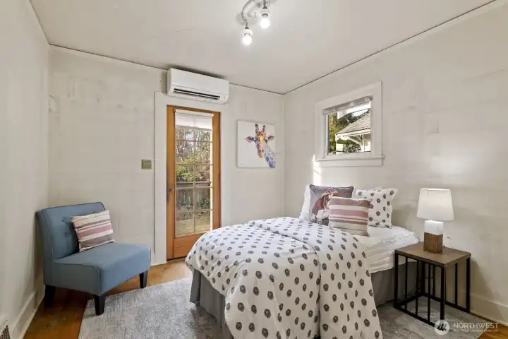 Second main floor bedroom, with a door leading to the back deck.