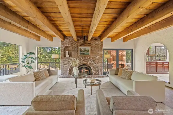 Livingroom is stunning with its brick fireplace and exposed beam ceilings.