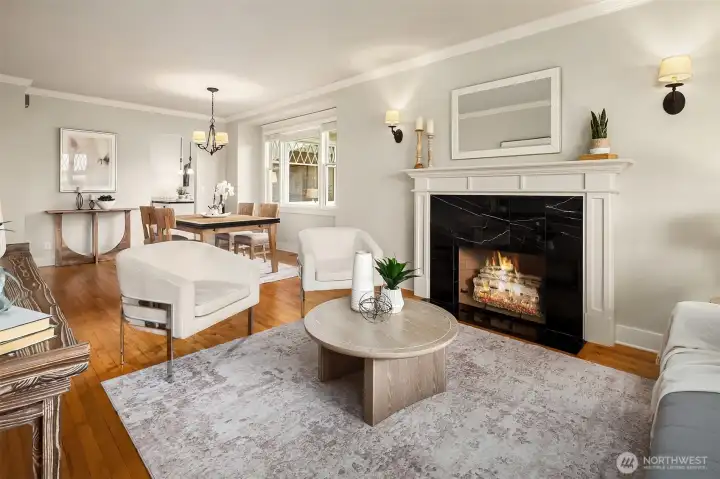 Living room with ample natural light. Fire added for visual (buyer to verify functionality).