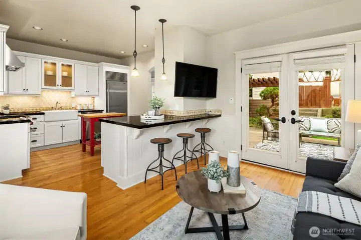 Flow between kitchen and sitting room with french doors opening to back deck.