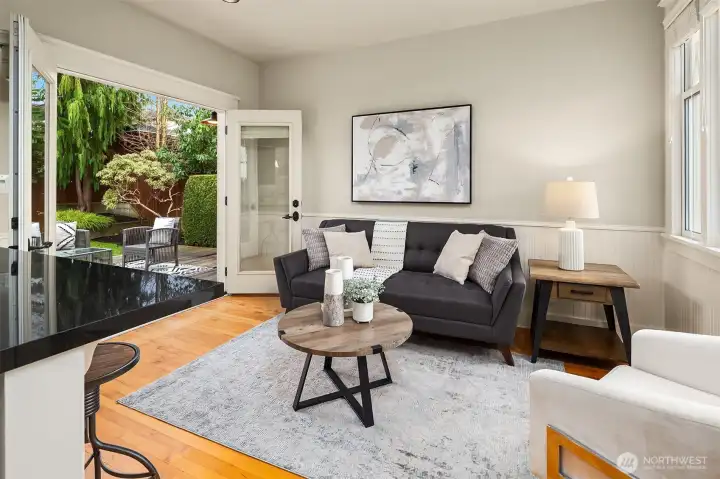 French doors opening to backyard entertaining space off of sitting area & kitchen.