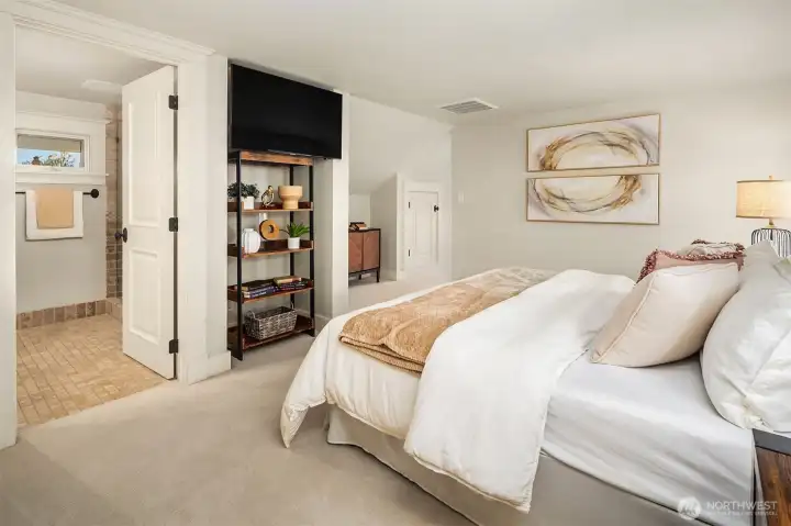 Primary bedroom with built in storage and ensuite bath.
