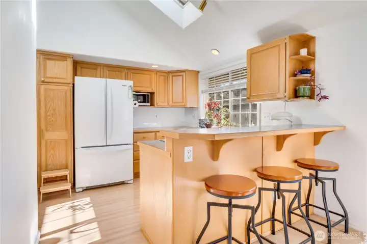 Lovely kitchen is central to the home featuring the breakfast bar and all appliances for the new owner.