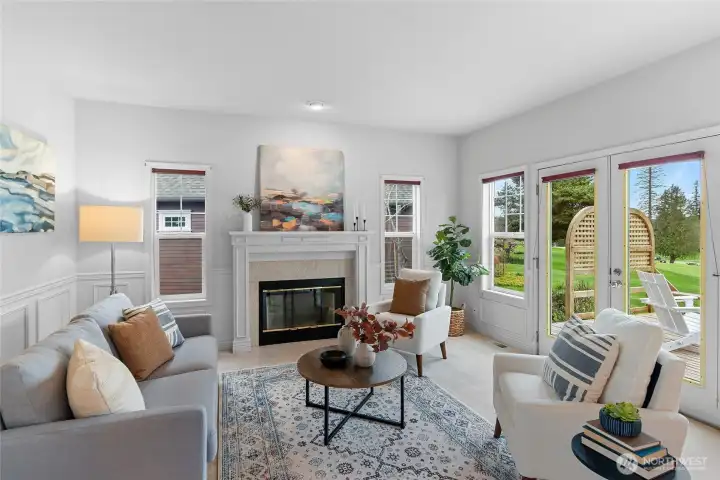 Living room with wainscotting, fireplace and deck access.