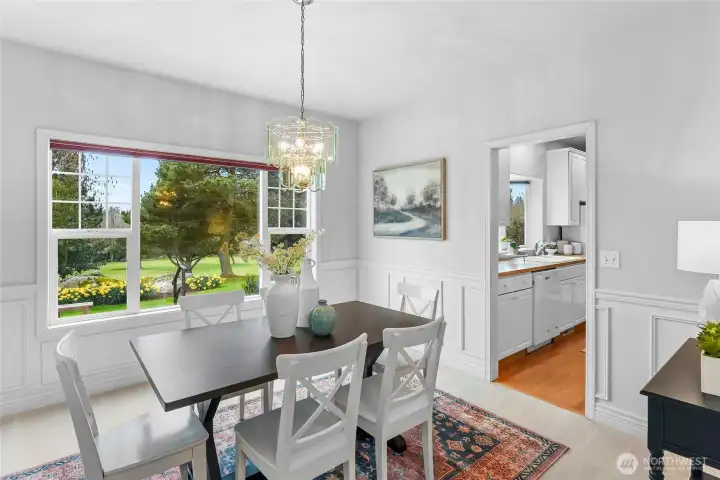 Formal dining room with golf course outlook.