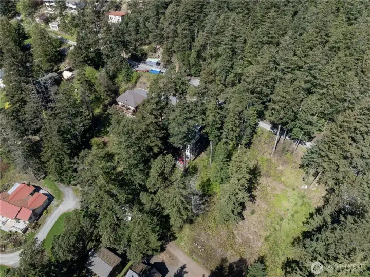 This .22 acre parcel lies immediately to the right of the homes in the photograph. The lot does not comprise the entire vacant area visible in this photo.