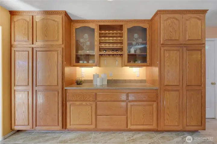Built-in buffet with glass-front display cabinets, wine rack, and abundant storage—perfect for serving, bar setup, or keeping dishes organized.