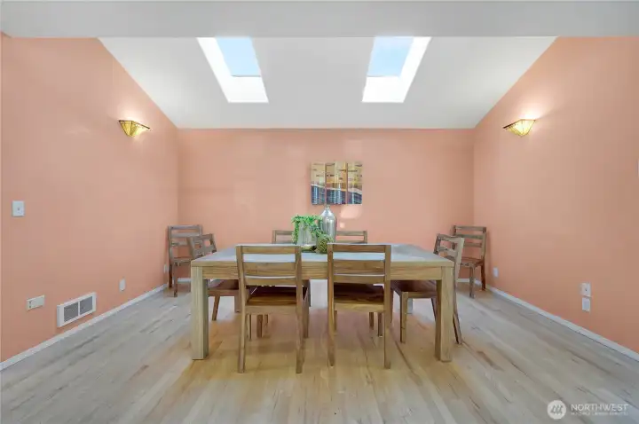 Bright Dining area with skylights directly off kitchen with access to back deck and yard