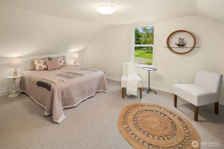 North side bedroom with cozy sloped ceilings.