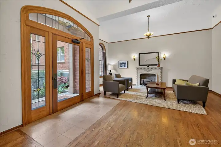 Step inside and feel the history. The stunning lobby features original stained-glass entry doors, warm hardwood floors, soaring ceilings, and a decorative fireplace, a shared living room that feels anything but ordinary.