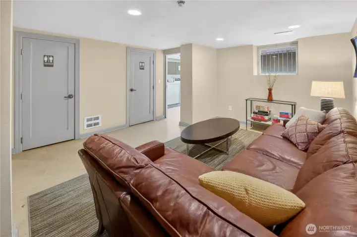 The lower-level rec room offers residents a comfortable lounge to unwind, with easy access to the building's free laundry facilities just steps away.