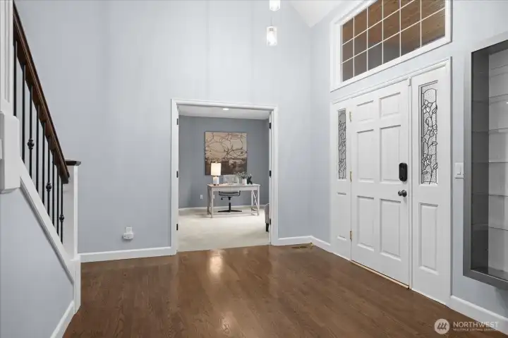 Soaring ceilings upon entry, main floor den pictured.