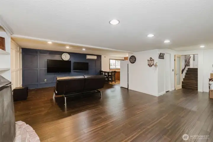 Another angle of the rec room shows entry to kitchen and stairs to the upper levels.