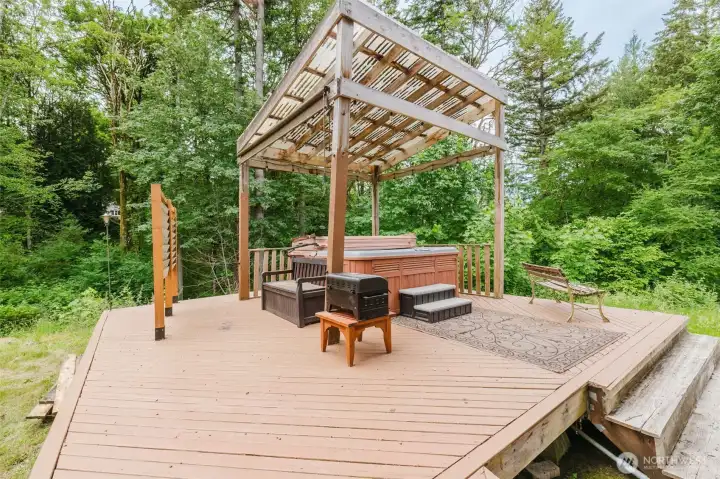 Separate deck with hot tub and cover to enjoy still on rainy days!