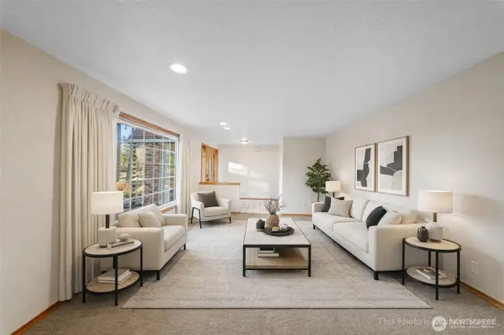 Virtually staged formal living room offers sunny views to the front of the property