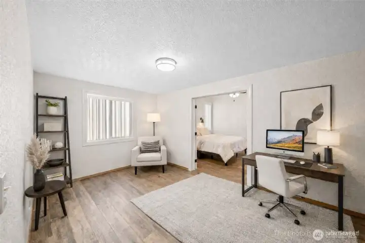 Office, den leads into the main floor primary suite. Virtually staged here