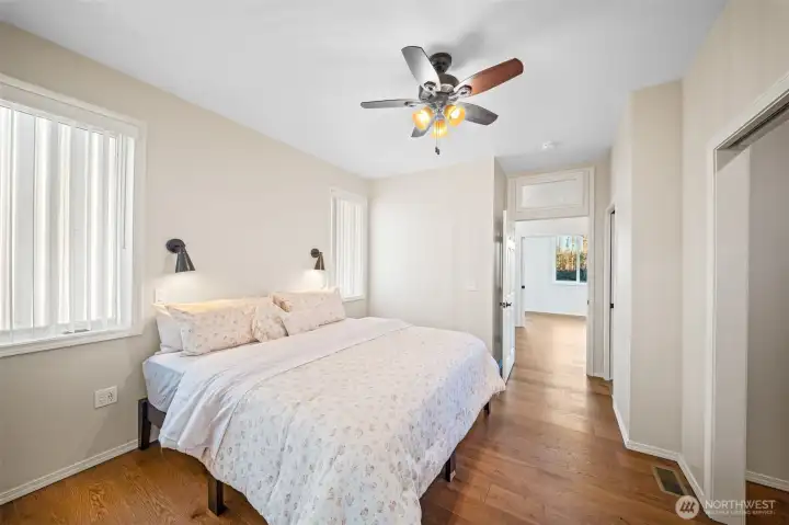 Main floor primary bedroom opens to another room with private entrance