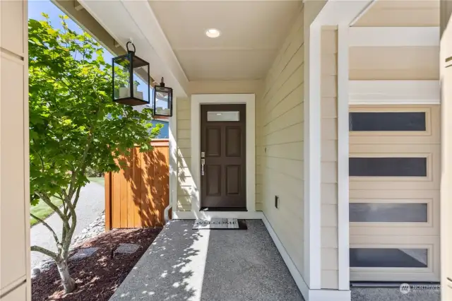 Large covered, well-lit entryway has a North-Facing door and is open to the Open Space on the East side of the home.