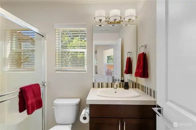 The LL 3/4 Bath is just off the Bonus Room.  Tile countertop w/ shaker cabinetry, glass backsplash, and natural light!