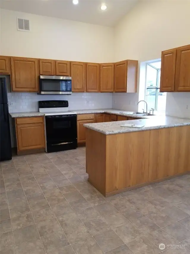 Kitchen with peninsula - photo is before renters moved in 2021