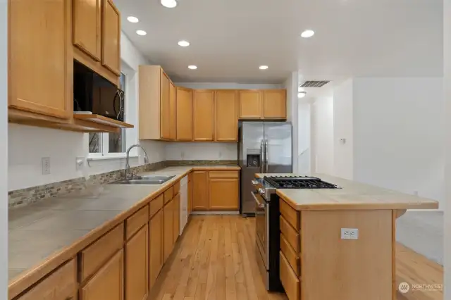 Kitchen: Spacious with wood cabinets