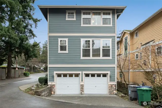 Rear Exterior: Modern two-car garage with extra parking space