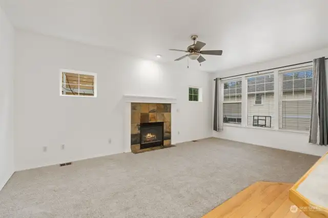 Living Room Fireplace - Cozy space with natural light and a warm fireplace.