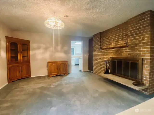 Formal dining room with wood burning fireplace and built in curio.