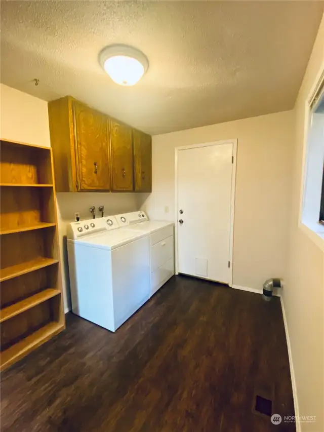 Large laundry room off kitchen with access to garage and guest bathroom.