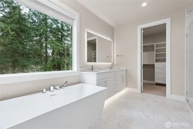 Deep soaking tub in primary suites with oversized windows and custom blinds that open/close and the touch of a button!