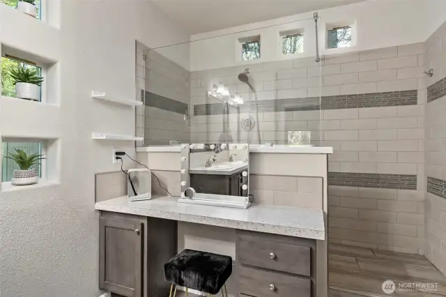 Vanity and tiled shower.