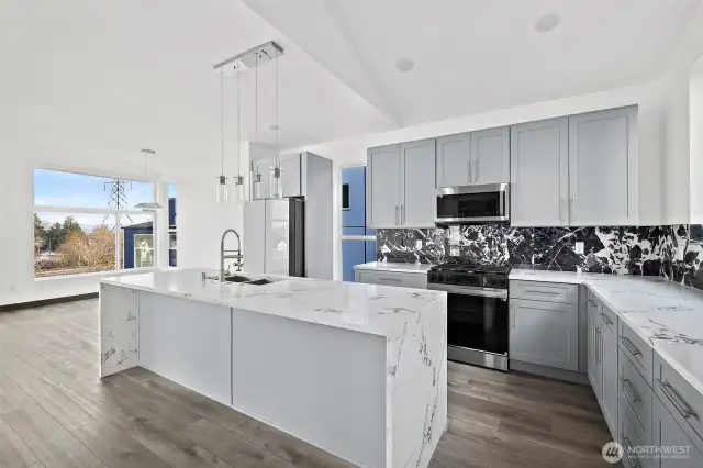 This kitchen showcases the lay out and high-quality finishes you can expect in the newly constructed home at 8608 & 8610 42nd Ave S, Seattle, WA 98118, built by the same builder.