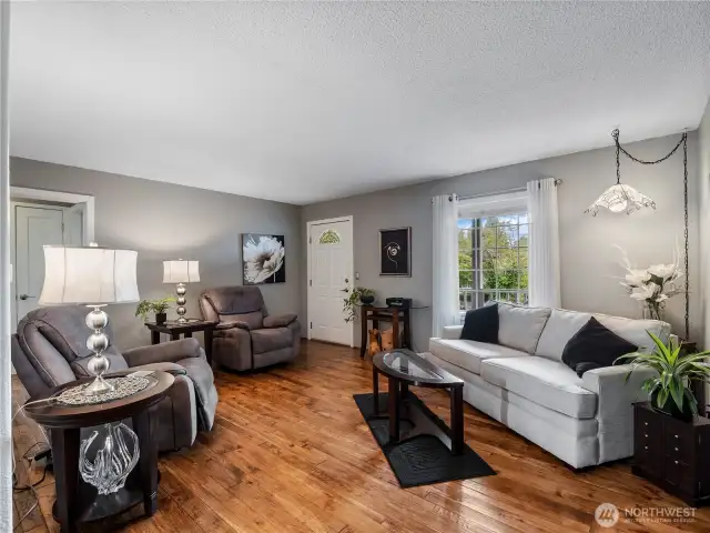 The living room features custom hand-hewn hickory hardwood floors.