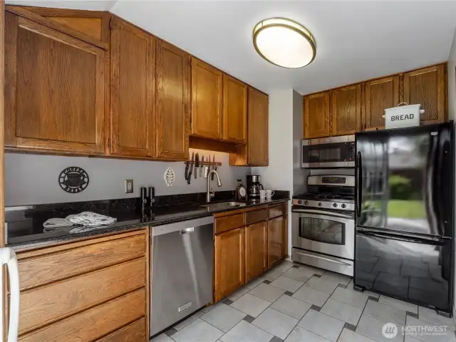 The kitchen stays bright with the large sliding glass door covering the back wall.
