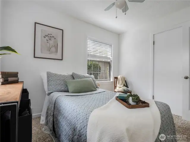 The second bedroom is on the back side of the house and has a window with a backyard view.