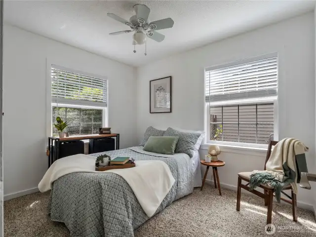 This bedroom is light and bright with its big windows.