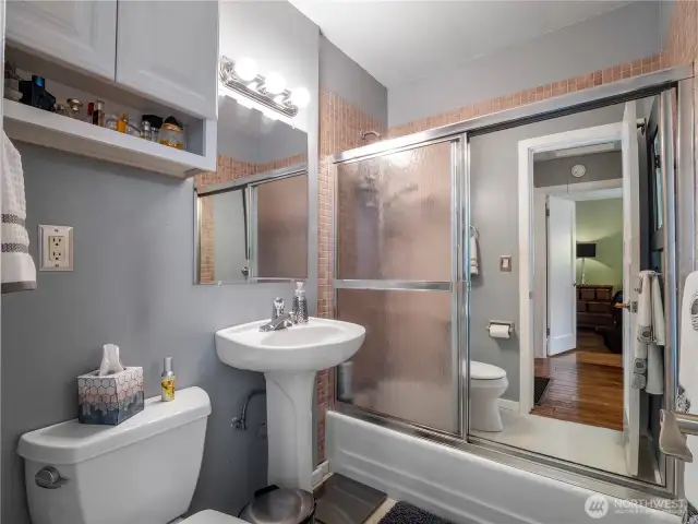 Next to the bedrooms, you will find the bathroom, which is off the living room.