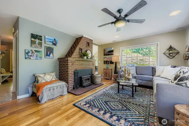 Living room features cozy wood burning fireplace insert