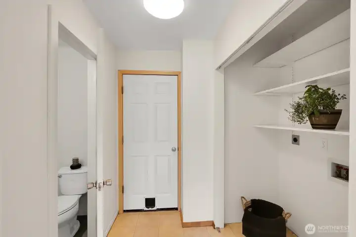 Laundry to the right, Garage straight ahead and half bath on left.