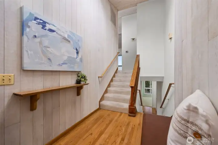 From the entry, one may go up to the living areas or downstairs to the two beds and baths.