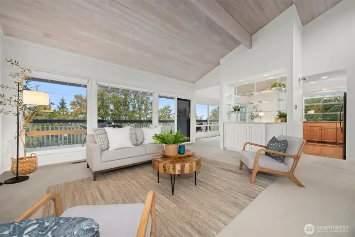 Looking across the living room toward the park and the bay views, with the kitchen and dining room beyond.