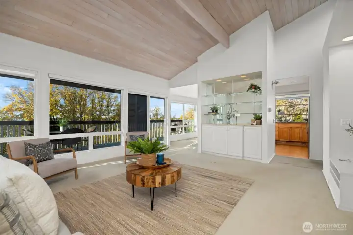 Looking across the living room toward the park and the bay views, with the kitchen and dining room beyond.