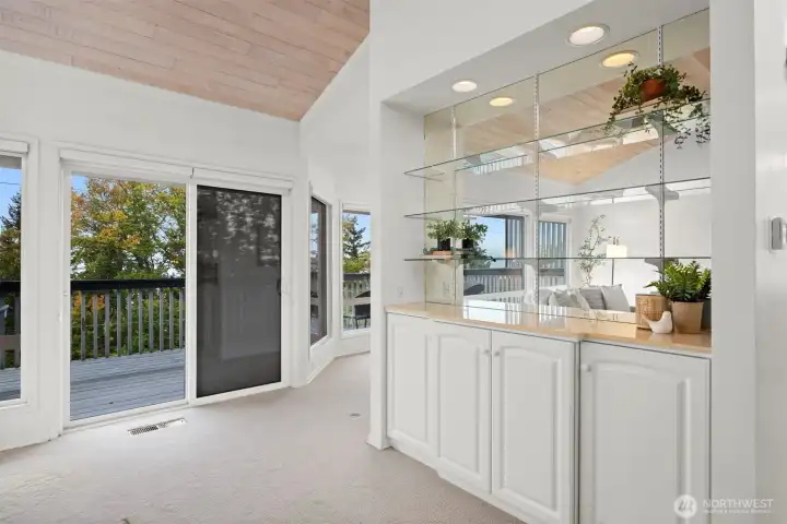 Another view of the bar area and the door that leads to the expansive deck. There are exterior shades for the windows, too.