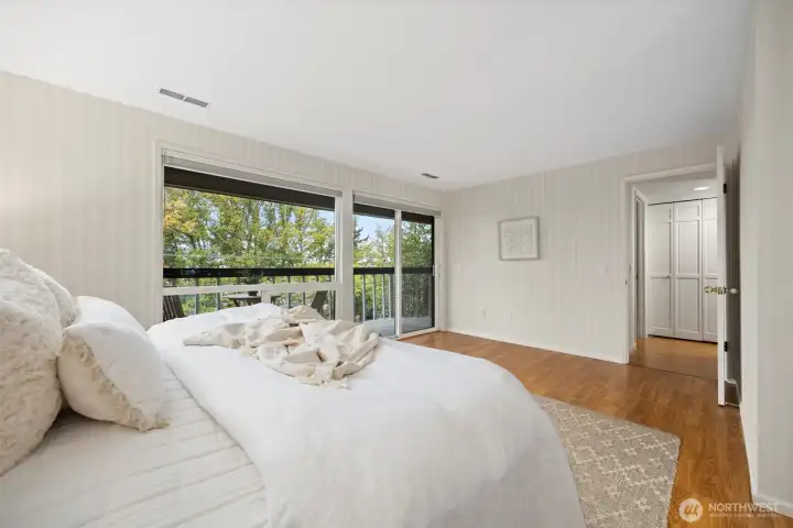 The primary bedroom is very spacious and gets so much sunlight with the window wall and glass sliding door.