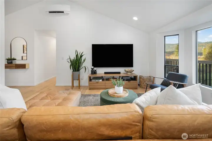 Living room with a wall of windows to the foothill views.