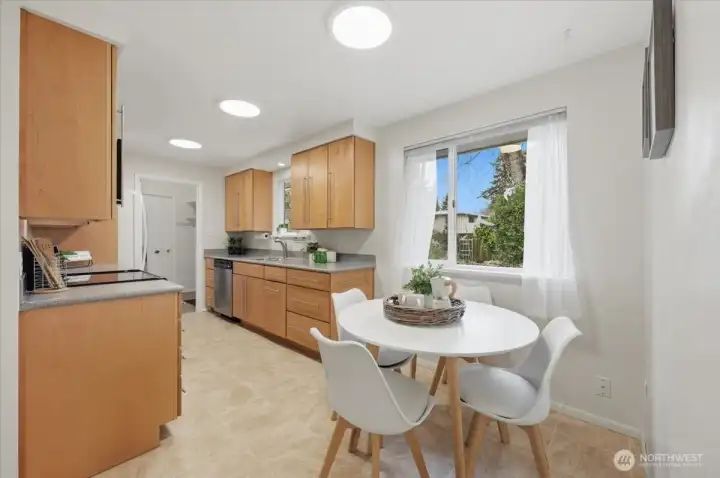 In kitchen dining offers ease and great flow in this seamless floor plan.  Home owners desiring a more formal dining setting in addition often use the nook near fireplace just around the corner and adjacent to living room.  I must say though, you'll absolutely love the view from this backyard picture window!  The current owner used an expansion table here offering seating changes from two-six  with ease and for those times dinner parties and or game nights were the focus.